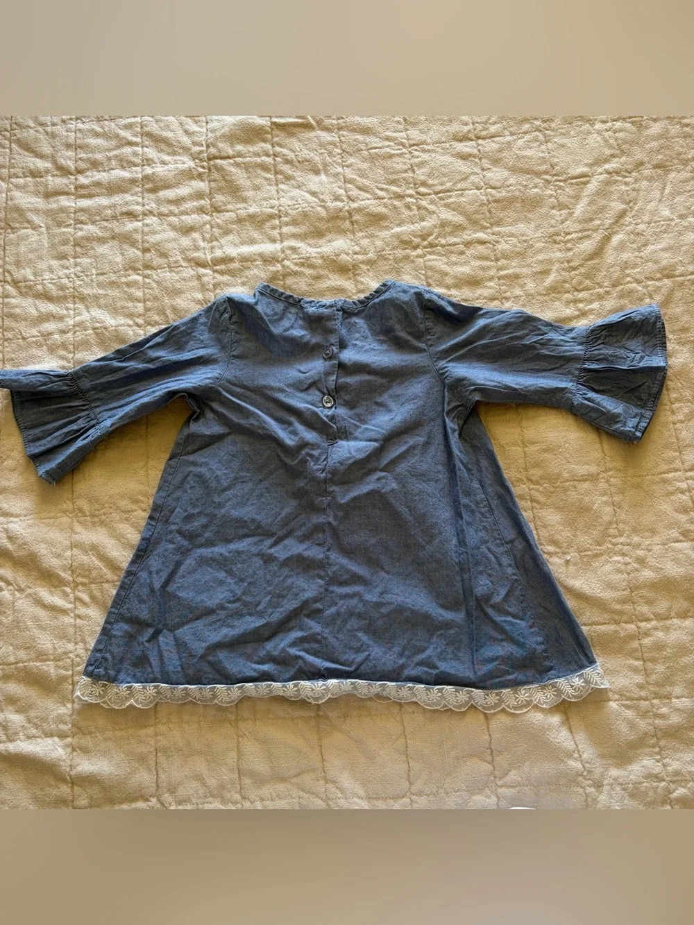 Girls Blue chambray dress with flower appliqué, flared sleeves, and floral lace